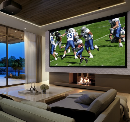 Modern dark media room showing a football game on a large projection screen